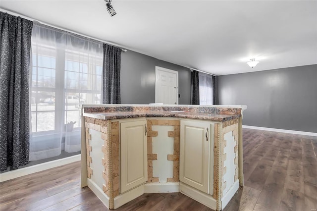 kitchen with a healthy amount of sunlight, wood-type flooring, and a kitchen island