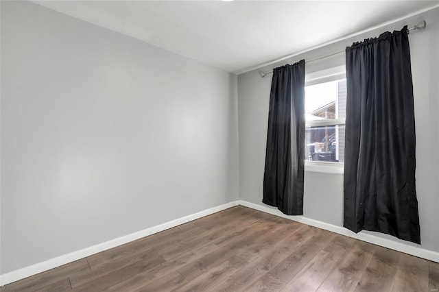 unfurnished room with wood-type flooring