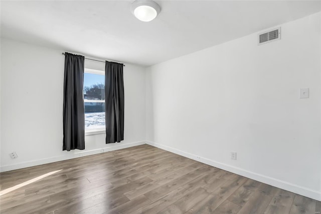 spare room with hardwood / wood-style flooring