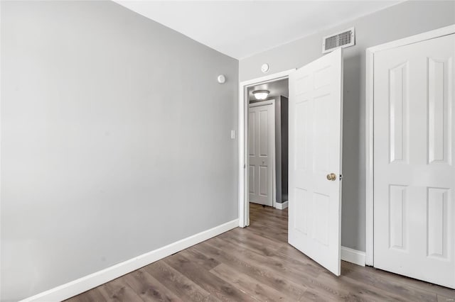 unfurnished bedroom featuring hardwood / wood-style flooring