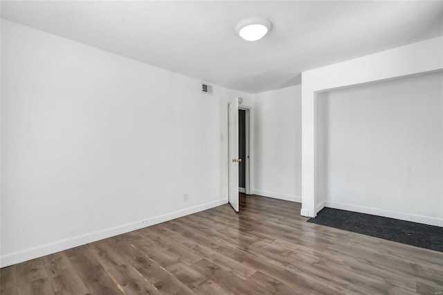 spare room featuring dark hardwood / wood-style floors