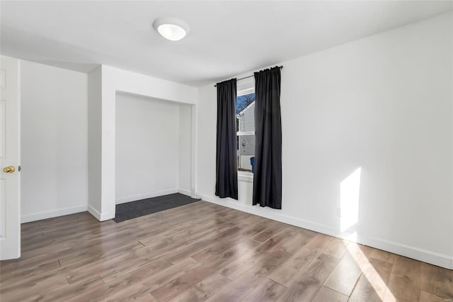 spare room featuring hardwood / wood-style floors