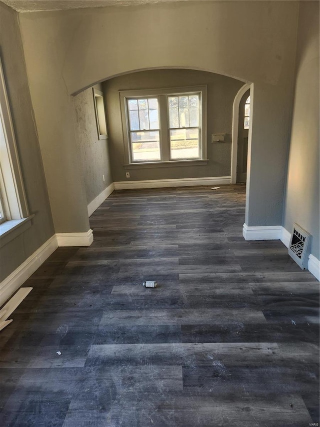 empty room with dark hardwood / wood-style floors