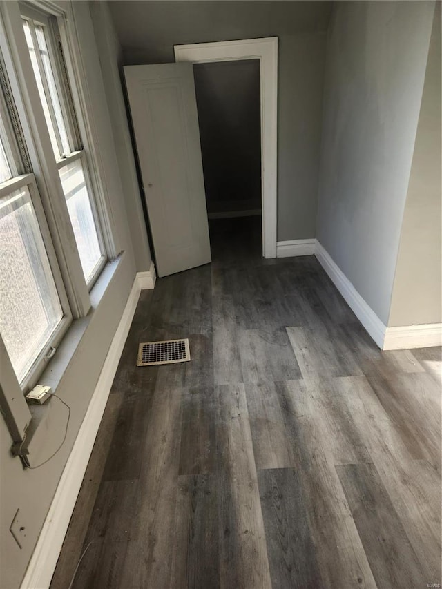 empty room with dark wood-type flooring