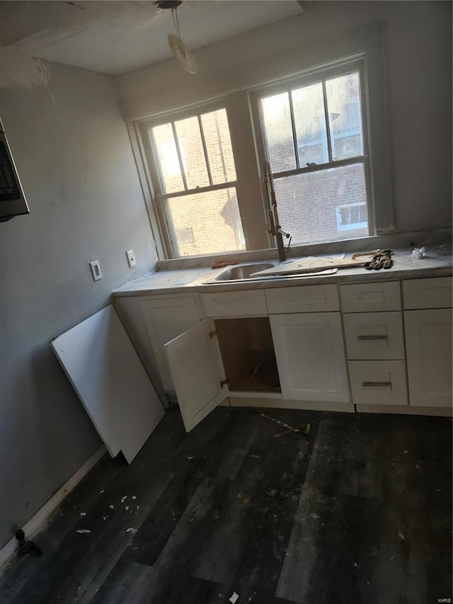 kitchen featuring sink, white cabinets, and a healthy amount of sunlight