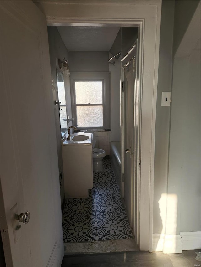 full bathroom with vanity, bathing tub / shower combination, tile walls, tile patterned flooring, and toilet