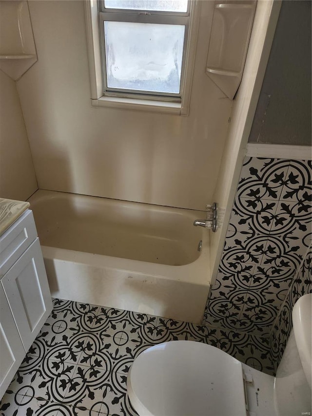 full bathroom featuring toilet, shower / bathing tub combination, vanity, and tile patterned floors