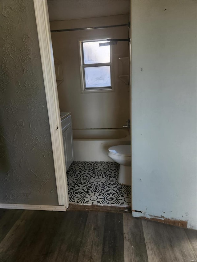 bathroom with toilet, vanity, and hardwood / wood-style flooring