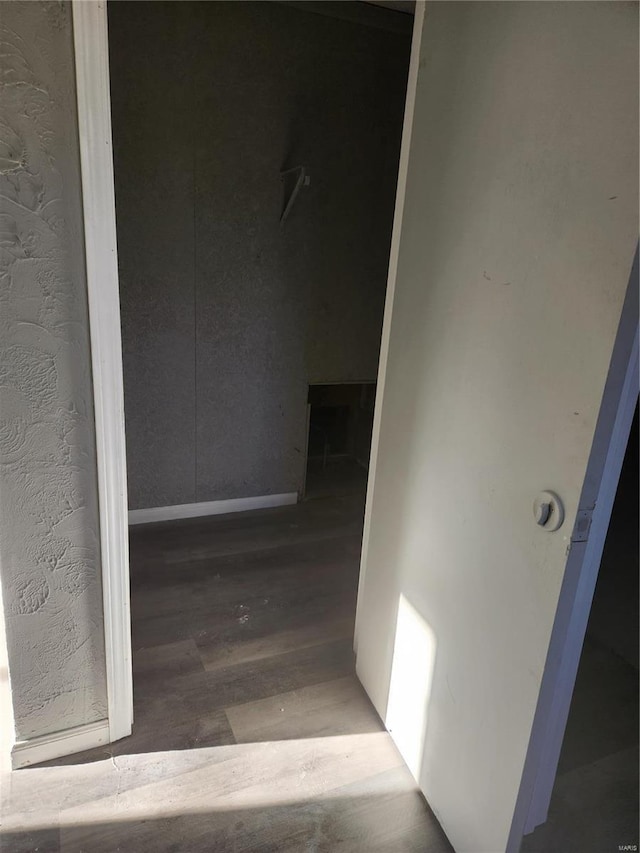 hallway with hardwood / wood-style floors