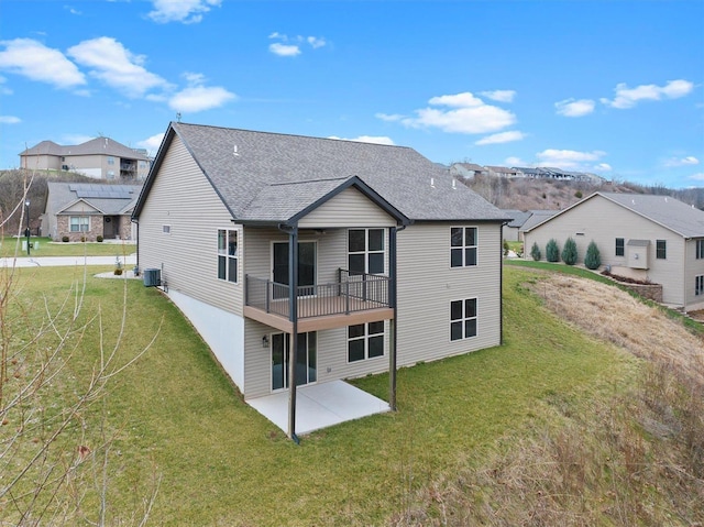 back of house with central air condition unit, a patio area, and a yard