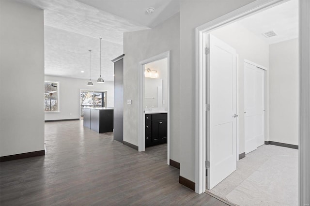 corridor featuring hardwood / wood-style flooring and lofted ceiling