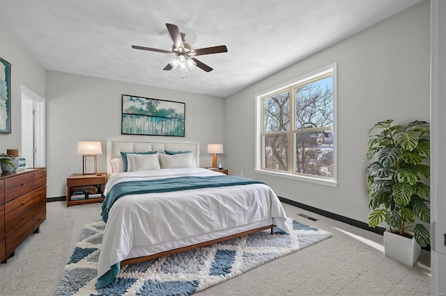 bedroom with ceiling fan and light carpet