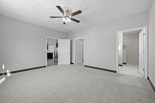 unfurnished bedroom with connected bathroom, light colored carpet, and ceiling fan