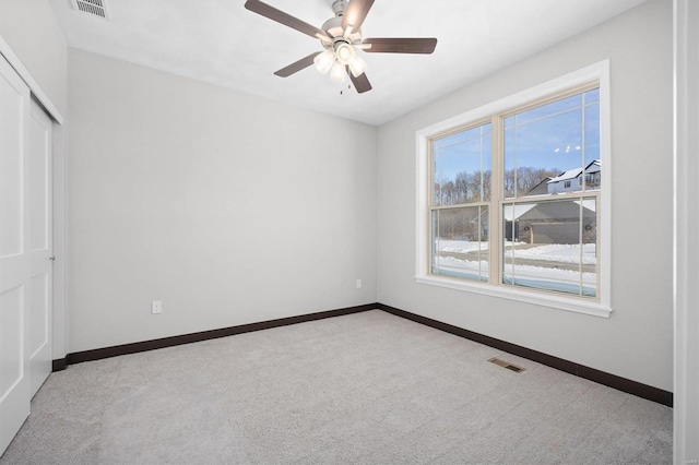 spare room with light carpet and ceiling fan