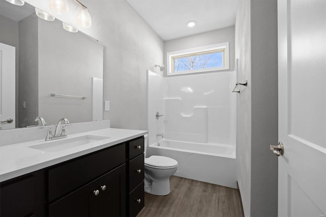 full bathroom featuring shower / tub combination, vanity, wood-type flooring, and toilet