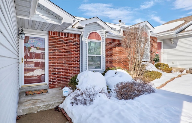 view of snow covered property entrance