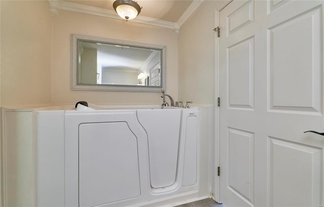 bathroom with a washtub, a textured ceiling, and crown molding