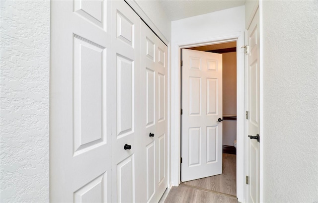 hallway with light hardwood / wood-style flooring