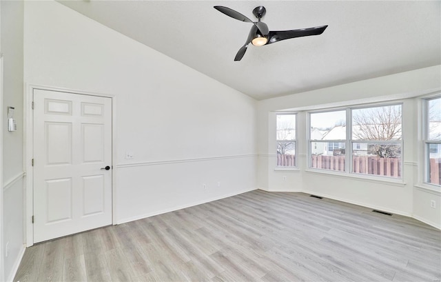 unfurnished room featuring vaulted ceiling, visible vents, and a healthy amount of sunlight