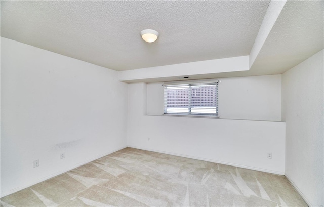 spare room with carpet flooring and a textured ceiling