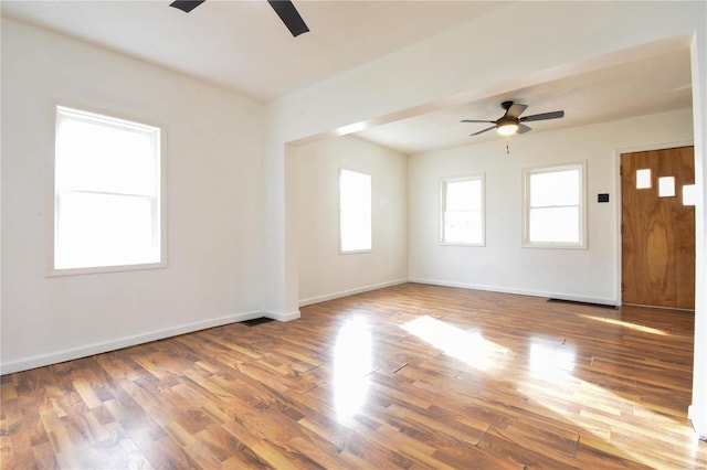 empty room with hardwood / wood-style floors and ceiling fan