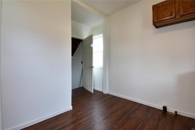 unfurnished room with dark hardwood / wood-style flooring