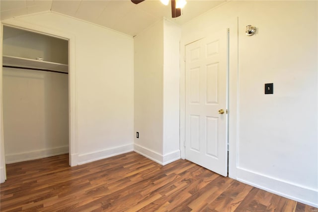 unfurnished bedroom featuring ceiling fan and dark wood-type flooring