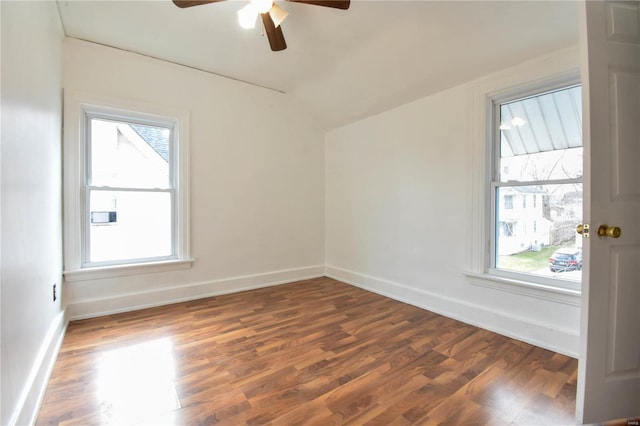 spare room with vaulted ceiling, ceiling fan, and dark wood-type flooring