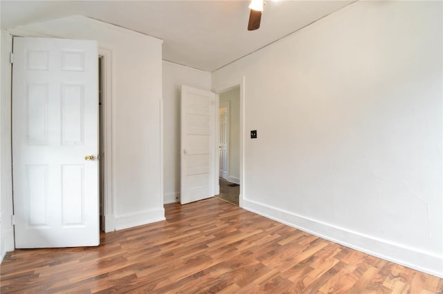 unfurnished bedroom featuring ceiling fan and dark hardwood / wood-style floors