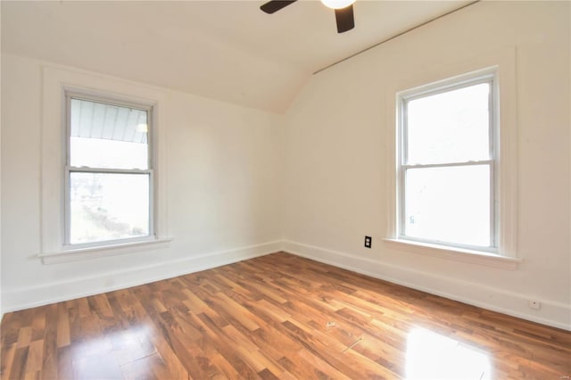 spare room with hardwood / wood-style floors, ceiling fan, and vaulted ceiling