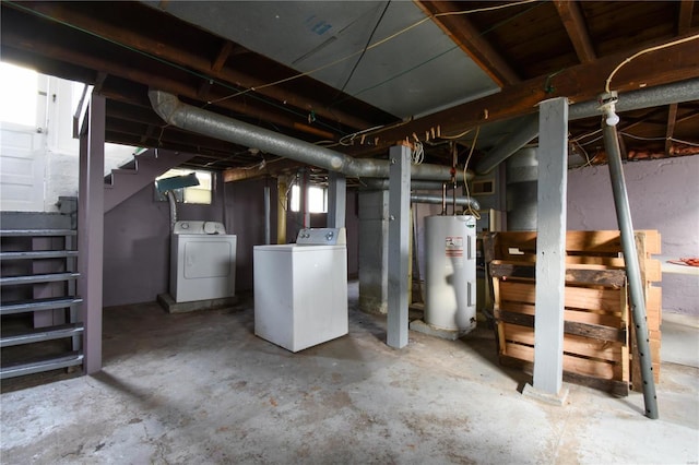 basement featuring water heater and independent washer and dryer