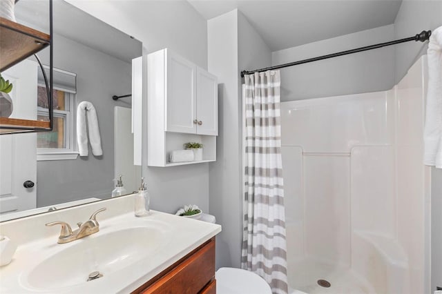 bathroom with vanity, a shower with curtain, and toilet