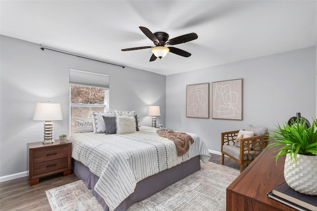 bedroom with ceiling fan and wood-type flooring