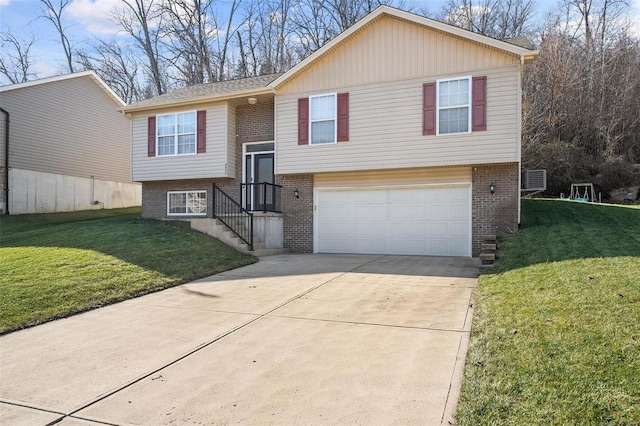 split foyer home with a garage and a front yard