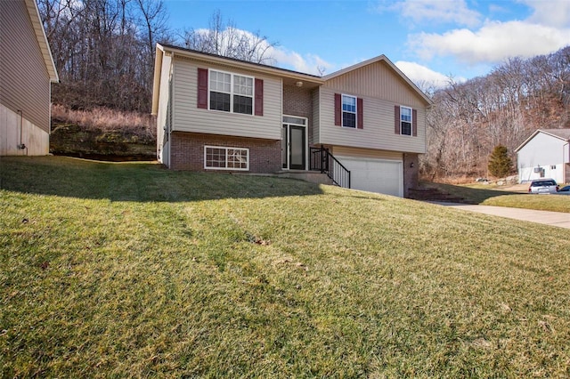 split foyer home featuring a garage and a front lawn