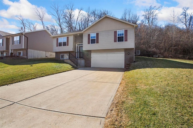 bi-level home featuring a garage and a front yard