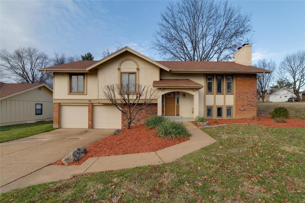 view of front of house with a front yard and a garage