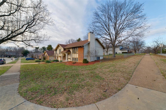 view of side of property with a yard