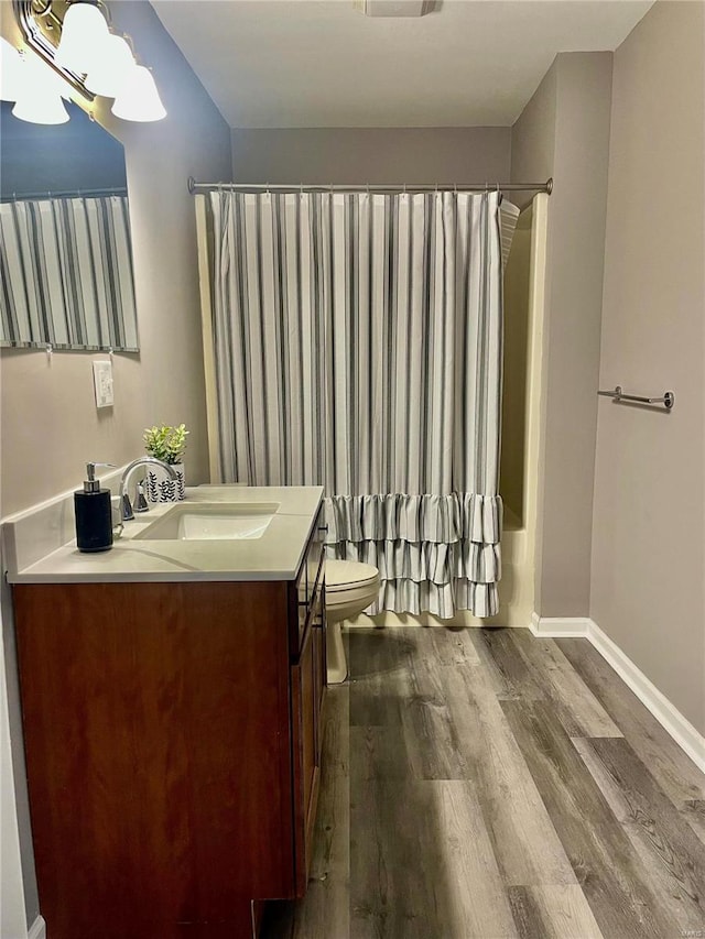 full bathroom with vanity, toilet, shower / bathtub combination with curtain, a notable chandelier, and wood-type flooring