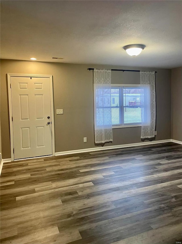 entrance foyer featuring dark hardwood / wood-style floors