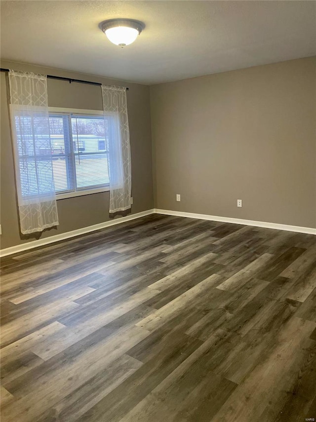 unfurnished room featuring dark hardwood / wood-style flooring