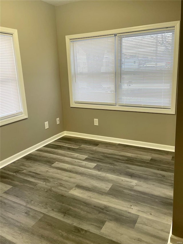 spare room with dark hardwood / wood-style flooring