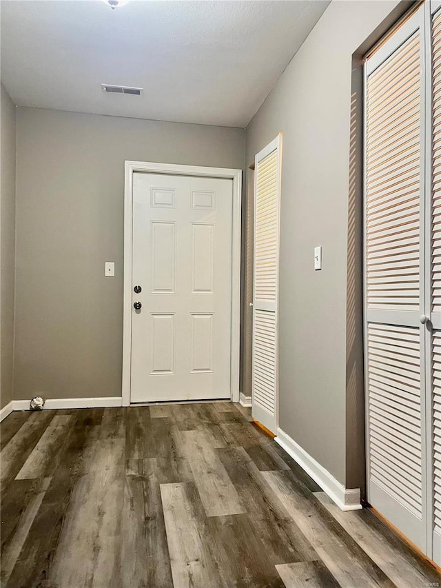 foyer entrance featuring wood-type flooring