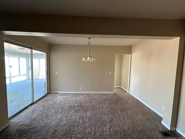 unfurnished room with carpet floors and an inviting chandelier