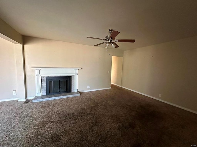 unfurnished living room featuring carpet flooring, ceiling fan, and a brick fireplace