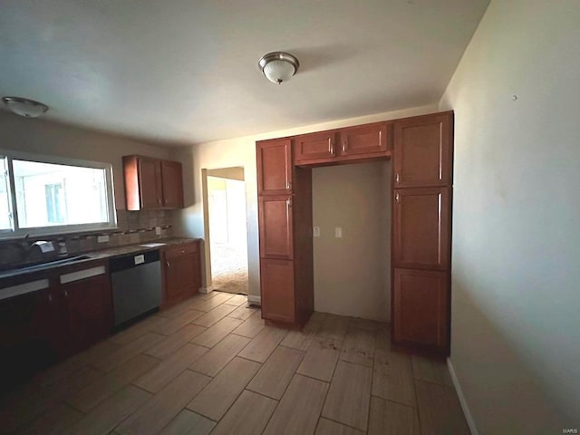 kitchen featuring dishwasher, decorative backsplash, and light hardwood / wood-style flooring