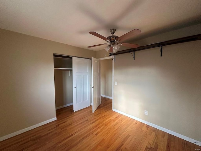 unfurnished bedroom with ceiling fan, light hardwood / wood-style flooring, and a closet