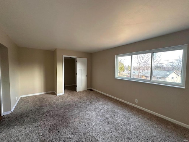 unfurnished bedroom with a closet and carpet floors