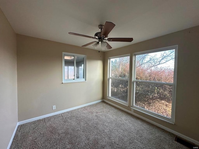 spare room featuring ceiling fan and carpet floors