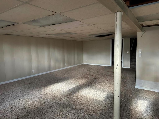 unfurnished room featuring carpet and a paneled ceiling